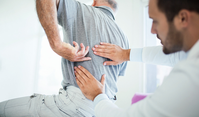 Doctor adjusting patients back